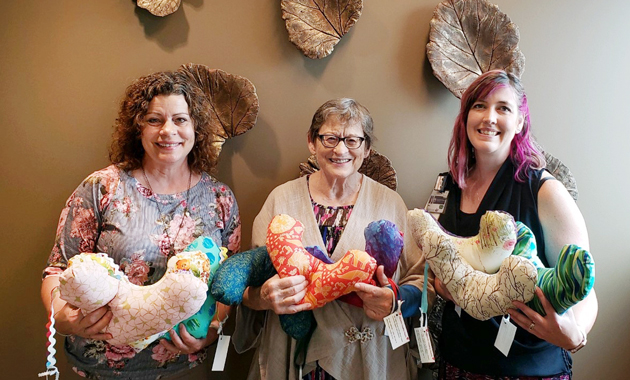 Three women with breast pillows